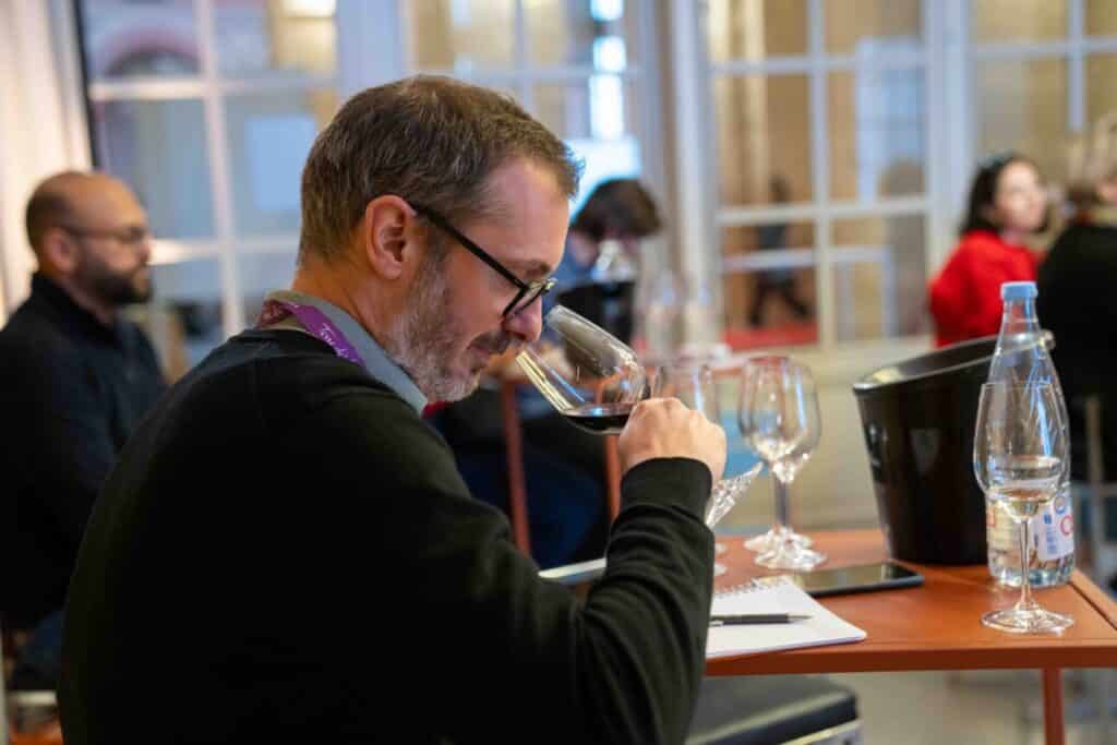 A guest tasting wine at Bordeaux Tasting at the Palais de la Bourse in winter